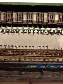 Unlike the pictures from deisignboom where the people make silk products with a handmade process, this small factory uses modern technology. Here you see the cocoon's threaded by the machine.
